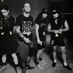 five men in black and white standing next to each other with tattoos on their arms