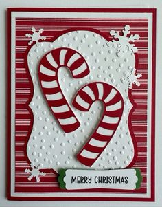 a christmas card with two candy canes on it