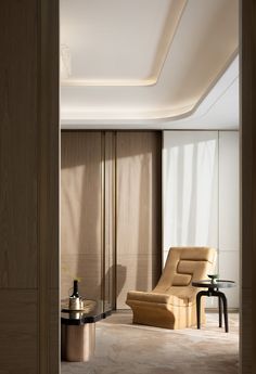 a living room with a chair and table in it's center area, next to a sliding glass door