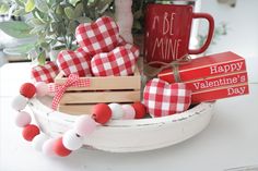 a basket filled with valentine's day items on top of a table next to a mug