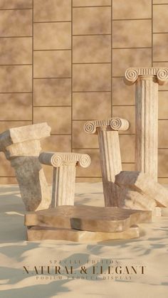 three stone pillars sitting next to each other in front of a wall