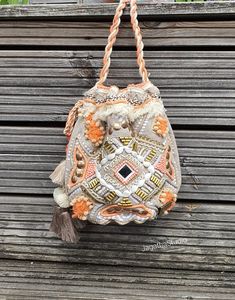 HANDMADE The perfect accessory, for a Boho Chic look! Inspired by a boho spirit, this chic bucket bag combines earth colors and textures with a touch of spark and natural beautiful tones. Crafted from cotton with beautiful details, beads work, pompons, embellish tassels, a fringe along the front and beautiful details, this bag won't be un notice. With beautiful double colour cotton strap, that can be worn as a should or cross body bag, by creating a knot with the strap. Ideal for a casual look o Boho Handbag, Look Boho Chic, Earth Colors, Boho Handbags, Beads Work, Bohemian Crystal, Boho Hippie Chic, Embroidered Bag, Star Gift