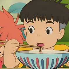 a boy and girl eating out of a bowl with chopsticks in front of them