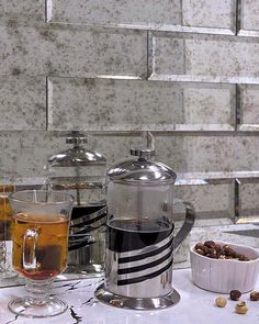 a table topped with two cups filled with liquid and nuts