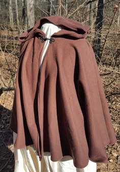 This short cloak is delightfully soft and comfortable. It's long enough to reach the back of the hand, keeping you warm but keeping your hands available when needed. It has a full hood and closes with a matching cloth frog clasp. This cloak is great for a costume piece or a cozy jacket, great for Spring, Fall, or over air conditioned buildings. Your cloak will measure about 30 inches in length. This listing is in a dark brown, but other colors are available in my store or on request. The materia Short Cloak With Hood, Romani Clothing, Prince Core, Brown Cloak, Inverness Cape, Short Cloak, Cloak Pattern, Medieval Cloak, Naruto Clothing