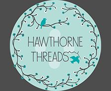 a round sticker with the words hawthornee threads in blue and white on it