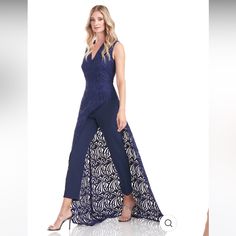 This Modern And Sophisticated Jumpsuit Showcases An Intricately Embroidered Lace Overlay In A Deep Navy Hue. Back Zipper Sleeveless V-Neck Asymmetrical Abstract Lace 100% Polyester Lined Dry Clean 5546676 Size & Fit Skirt Length: 43.5" From Waist To Hem Inseam Length: 25.5" Model Measurements: 5'11" Tall Model Is Wearing A Size 4 Fitted Blue Floor-length Jumpsuits And Rompers, Blue Fitted Floor-length Jumpsuits And Rompers, Blue Fitted Floor-length Jumpsuit, Elegant Blue Wedding Jumpsuits And Rompers, Walk Through Jumpsuit, Modern Jumpsuit, Crepe Pants, Fit Skirt, Maxi Romper