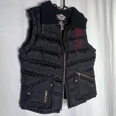 Harley Davidson Motorcycles Biker Vest Puffer Riding Vest With Adjustable Cord In Back Of Vest To Block Wind. Perfect Condition, Brand New Without Tags! Red And Black All Pockets Are Functional. Logo And Detailing On Inside. Soft Warm Lined Material. Embroidered Design On Front And Logo Embroidered On Back. Measurements For Waist And/Or Hip Are Taken Zipped Or Buttoned Up And Laid Comfortably Flat Then X2 For Total Circumference (Inches) Length From Front: 22” Length From Back: 22” Shoulder Widt Vest Puffer, Riding Vest, Harley Davidson Jacket, Biker Vest, Harley Davidson Motorcycles, Puffer Vest, Embroidered Design, Logo Embroidered, Red And Black