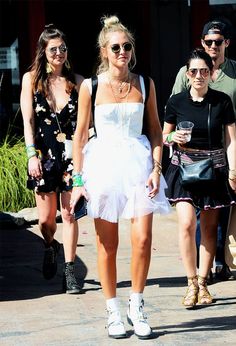 two women in white dresses walking down the street