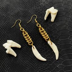 Ethically sourced drilled coyote canine teeth attached to handmade chain mail links! Teeth are natural and may have minor imperfections/discoloration. Ear wire is nickel and lead free and comes with rubber tips!  Earrings are on a hand stamped/ hand drawn backing and come in a mesh bag or pillow box with crinkle paper.  I also include a random teabag and candies (vegan) if you do not want this included please leave a note (: some orders may include a mini crystal or two! Teeth Earrings, Bone Earrings Handmade, Gothic Gold Brass Earrings, Bird Skull Earrings, Oddity Earrings, Oddities Jewelry, Chain Mail Earrings, Animal Bone Jewelry, Edgy Skull-shaped Pierced Earrings