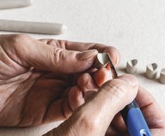 a person is drawing something with colored pencils