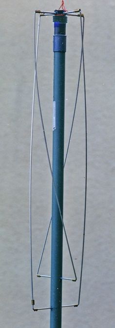 a bird perched on top of a blue pole with wires attached to it's sides