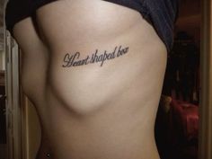 a woman with a tattoo on her stomach that says, i heard shaped be in cursive writing