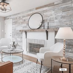 a living room filled with furniture and a fire place in front of a brick wall