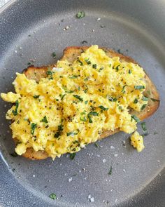 an omelet is sitting on top of a piece of bread in a pan