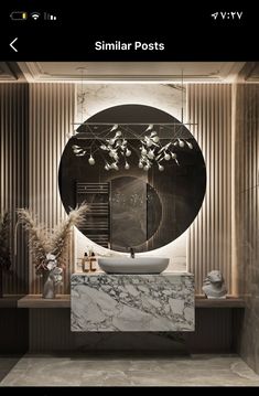 a bathroom with marble counter tops and an oval mirror above the sink in front of it