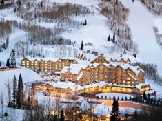 a ski resort lit up at night in the mountains