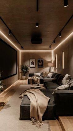 a living room filled with lots of furniture next to a flat screen tv mounted on the wall