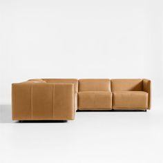 a brown couch sitting on top of a white floor