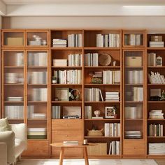 a living room filled with lots of wooden bookshelves