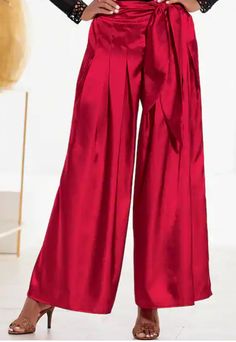 Shavon Satin Pant Product Details It's so easy to be elegant in ruby satin! Wide leg pant has flattering pleats and a dramatic, waist-defining tie. Back elastic waist. 30" inseam. Polyester; machine wash. Imported. Ruby. Satin Pant, Holiday Pants, Christmas Wear, Satin Pants, Red Pants, Wide Leg Pant, Red Jacket, Ruby Red, Waist Tie