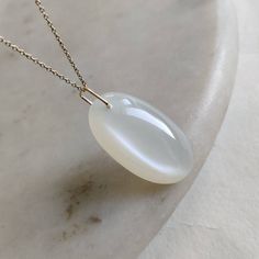 This stunning pendant is set in 14k Solid Yellow Gold with Natural White Moonstone with utmost precision. It is an unique gemstone pendant for nearly every occasion and is completely hassle-free jewelry. ◾ITEM DETAILS * Gem: White Moonstone * Gem Size: 17x32 mm * Gem Shape: Oval cab * Gem Weight: 37.50 carats * Gold Purity: 14KT  * Gold Weight: 0.168 gram * Total Weight of the Pendant: 7.67 gram The Gold purity is guaranteed and it comes with an authentic 14KT gold hallmark. Since my items are h Handmade Jewelry Box, White Moonstone, Jewelry Christmas, Birthstone Pendant, June Birthstone, Moonstone Jewelry, Moonstone Pendant, Unique Gemstones, June Birth Stone