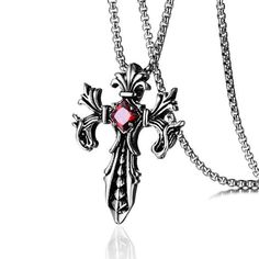 Intricately crafted from a titanium steel alloy, this exquisite pendant features a complex design. The center is embellished with a diamond-shaped crystal available in either a blood-red or clear black variation. Surrounding the crystal is a dragon-like patterned cross, with the cross leg carrying a centered scale-like carving that runs from top to bottom, curtained by silver curved borders. The arms of the cross are made of 2 separate silver spirals, one twisting inward in 3 firelike rays while the lower end is an abstract metallic semblance of a dragon head. The entire piece from Innovato Design is an exquisite rustic silver.  Product Highlights   Made from Titanium Steel  Includes 18" chain necklace with 5 cm extender  Exquisite cross pendant design Sporty Streetwear, Skull Pendant Necklace, Hanging Necklaces, Double Dragon, Crystal Cross, Mens Jewelry Necklace, Skull Pendant, Dragon Pendant, Mens Leather Bracelet