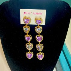 These Are A Very Beautiful Pair Of Dangly Heart Earrings That Are Made By Betsey Johnson. They Are Brand New And Have Never Been Worn!! In Excellent Condition. They Are Made Up Of Gold-Toned Hearts Hanging Down With Purple And Beautiful Green-Blue Stones. The Hearts Have Diamond-Like Rhinestones Around The Outside Of Each Heart. Beautiful!! Purple Earrings For Valentine's Day Party, Heart Shaped Purple Jewelry For Party, Purple Dangle Heart Earrings For Pierced Ears, Purple Earrings For Valentine's Day, Heart-shaped Purple Jewelry For Party, Purple Drop Earrings For Valentine's Day, Purple Heart-shaped Jewelry For Party, Purple Heart-shaped Earrings For Pierced Ears, Purple Heart-shaped Pierced Earrings