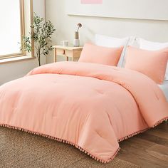 an orange comforter on a bed in a bedroom