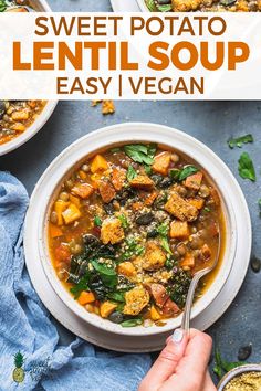 a bowl of sweet potato lentil soup with spinach and bread on the side