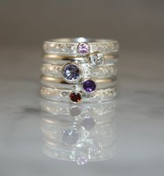 "Stacking Family Ring made with Sterling Silver and Gemstones. Made to Order This custom made set of stacking rings nestle very nicely beside one another. The rings are stunning with different colors of gemstones so even if you don't want a family ring, I would be happy to work with you to create a beautiful and unique ring just for you. This custom made set of family rings is made with 5 separate solid sterling silver bands, sterling silver bezels and gemstones. Each individual ring band measur Silver Gemstones With Bezel Setting For Anniversary, Silver Stackable Gemstones For Anniversary, Silver Stackable Rings With Gemstone Accents, Stackable Sterling Silver Rings With Accent Stones, Sterling Silver Stackable Rings With Accent Stones, Silver Stackable Rings With Gemstone Accents For Anniversary, Silver Stackable Amethyst Ring For Anniversary, Sterling Silver Stackable Rings For Anniversary, Silver Stackable Rings With Accent Stones