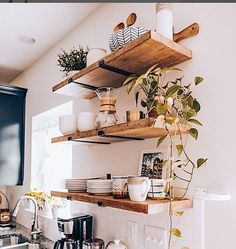 the kitchen is clean and ready to be used for cooking or baking, with dishes on shelves above the sink