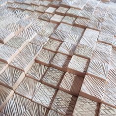 a close up view of an artistic tile pattern made from wooden blocks and plywood