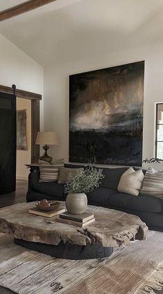 a living room filled with furniture and a painting on the wall