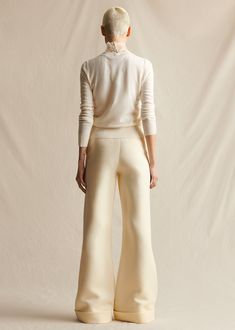 Our classic wide leg trousers made from Italian silk wool. Features an elongating pintuck at the front and a cuff at the ankle. Styled with the Embroidered Top In Pearl Lattice Style Number: AL513SW Made in New York City Size & FitModel's Height: 5'10"Model is wearing size 2 Measurements based on a size 4: Front rise (excluding waistband) 9.625" Back rise (excluding waistband) 14.5" Inseam 36.25" Composition & CareComposition: 77% Wool, 23% Silk Washing Instructions: Dry Clean Only Formal Cream Wide-leg Bottoms, Tailored Cream Wide Leg Pants For Formal Occasions, Chic Cream Wide Leg Pants For Formal Occasions, Classic Silk Wide Leg Pants For Evening, Chic Beige Wide Leg Pants For Evening, Elegant Wide-leg Silk Pants, Elegant Beige Silk Pants, Chic Tailored Silk Wide Leg Pants, Tailored Silk Wide Leg Chic Pants