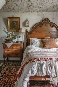 an old fashioned bed with pillows and blankets on top of it in a room that has been painted white