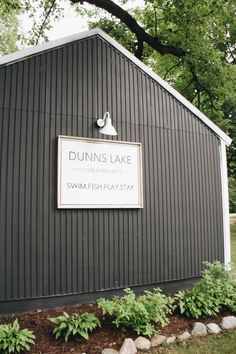 a sign on the side of a building that says dunins lake swim and play stay