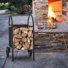 a fire pit with logs in it and a cart full of wood next to it