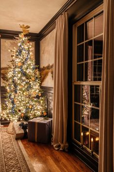 a decorated christmas tree in the corner of a room