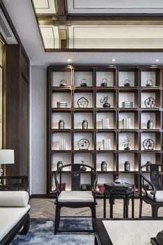 a living room filled with lots of furniture and bookshelves