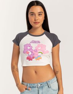 Care Bears Raglan Baby Tee. Large Graphic Screened On Front. Crewneck. Contrast Neckline And Short Sleeves. Shrunken Fit. 50% Cotton, 50% Polyester. Machine Wash. Imported. Model Is Wearing A Size Small. Model Measurements:height: 5'7" Bust: 34"waist: 25"hips: 34.5" Playful White Fitted Top, Playful Fitted Graphic Print Tops, Playful Fitted Crew Neck Top, Playful Fitted White Top, Playful Fitted Top With Graphic Print, Cute Gray Top With Graphic Print, Cute Gray Crew Neck Top, Gray Crew Neck Cute Tops, Playful Cotton Crop Top