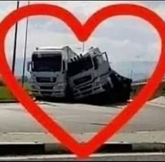 two trucks in the middle of a road with a red heart shaped frame over them