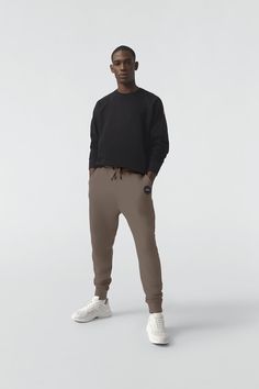 Made with 100%  Cotton for breathability and comfort, the Huron Pant has a rib-knit waist and cuffs for a tailored fit and a zippered back pocket. Sporty Pants With Ribbed Cuffs For Work, Casual Loungewear Pants With Minimal Stretch, Men Parka, Baby Outerwear, Mens Parka, Snow Pants, Waist Pack, Back Pocket, Bottom Clothes