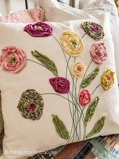 a white pillow with flowers on it