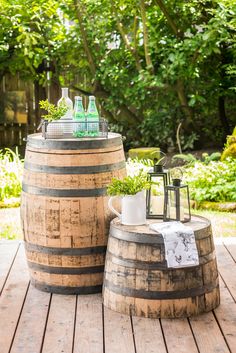 two wooden barrels sitting on top of a wooden table