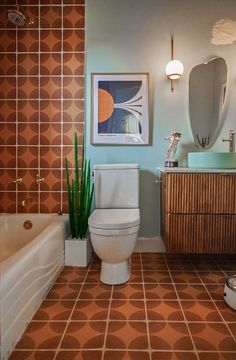 a bathroom with a toilet, sink and bathtub next to a painting on the wall