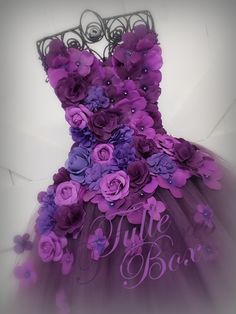 a dress made out of purple flowers with the words life is beautiful written on it