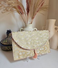 Golden evening clutch golden wedding clutch clutch bag small shoulder strap designer bag. Our Daardart clutch is the combination of chic style, originality and uniqueness. It is the ideal choice to add a touch of elegance and sophistication to your evening or wedding outfits. Made from carefully selected upholstery fabric scraps, each pouch is one of a kind. The satin lining adds a touch of comfort and elegance, while the snap closure helps keep your belongings secure. The clutch can be carried Luxury Beige Evening Bag For Gift, Handmade Beige Evening Bag For Events, Handmade Cream Evening Bag For Gift, Handmade Cream Evening Bag As Gift, Luxury Cream Evening Bag As Gift, Cream Pouch Evening Bag For Gift, Chic Gold Bag For Gifting, Cream Pouch Evening Bag Gift, Cream Pouch Evening Bag As Gift