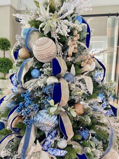 a blue and white christmas tree decorated with ornaments