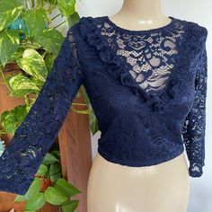 Sexy Whimsical Crop Top In A Sheer Lace Fabric In The Back And On The Sleeves, The Front Of The Top Is Lined, It Is So Soft And Stretchy So It Fits To The Body! Has A V Ruffle In Front With Long Sleeves And A Single Button Closure In Back. New Without Tags, Never Been Worn Bust- Approx 15-17" Across Underarm To Underarm (Stretched To Unstretched) Approx 12-14" Across The Bottom Of The Crop Top (Stretched To Unstretched) Sleeve-17" From Shoulder Seam To Bottom Of Sleeve Length- Approx 9" Long From Underarm To Bottom Of Blouse New With Tags - No Flaws To Determine Fit, We Recommend Comparing The Measurements Of The Item With An Item Of Similar Cut That You Own. Long Sleeve Crop Top With Lace Trim For Party, Long Sleeve Lace Trim Crop Top For Party, Fitted Lace Crop Top With Ruffles, Fitted Blue Lace Top, Blue Fitted Lace Top, Ruffled Crop Top Blouse For Party, Party Ruffle Crop Top Blouse, Party Ruffled Crop Top Blouse, Blue Ruffled Party Tops